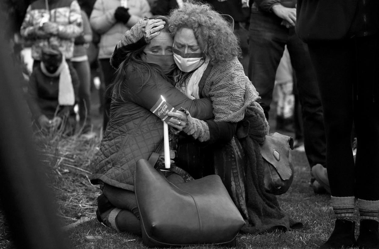 Mourners hug at a vigil for the victims of a mass shooting at a grocery store earlier in the week, Wednesday, March 24, 2021, outside the courthouse in Boulder, Colo. (David Zalubowski/AP)