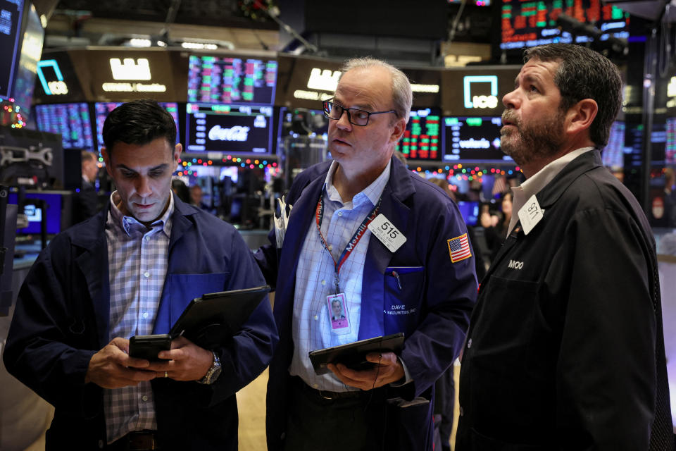 Traders work at the post where Carvana Co. is traded on the floor of the New York Stock Exchange (NYSE) in New York City, U.S., December 7, 2022. REUTERS/Brendan McDermid