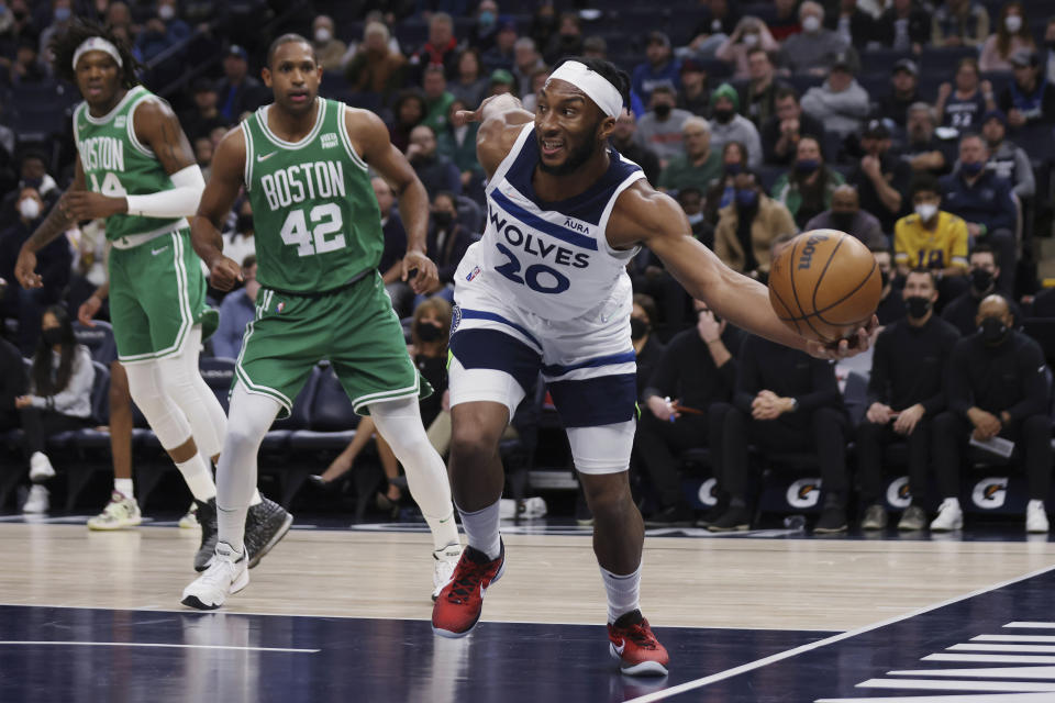 Minnesota Timberwolves forward Josh Okogie (20) tries to keep the ball in play, against the Boston Celtics during the first half of an NBA basketball game Monday, Dec. 27, 2021, in Minneapolis. (AP Photo/Stacy Bengs)