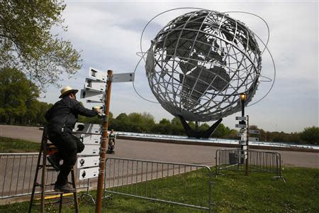 An artist works on a piece marking the 50th anniversary of the 1964 World's Fair at Flushing Meadows -Corona Park in the Queens borough of New York May 12, 2014. REUTERS/Shannon Stapleton