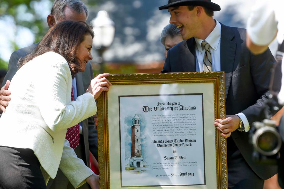 Susan Bell, wife of President Stuart Bell who is clapping at left, is honored with the Amanda Grace Taylor Watson Distinctive Image Award during the Tapping on the Mound ceremony, a part of Honors Week at the University of Alabama.