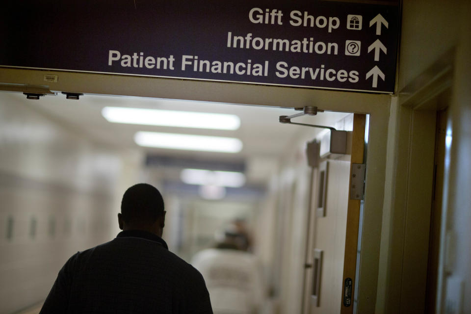 In this Friday, Jan. 24, 2014 photo, a sign points visitors toward the financial services department at Grady Memorial Hospital, in Atlanta. In two years, federal payments to hospitals treating a large share of the nation’s poor will begin to evaporate under the premise that more people than ever will have some form of insurance under the federal health care law. The problem is that many states have refused to expand Medicaid, leaving public safety net hospitals there in a potentially precarious financial situation and elected officials facing growing pressure to find a fiscal fix. And in an election year, Democrats are using the decision by Republican governors not to expand Medicaid as a major campaign issue and arguing the hospital situation could have been avoided. (AP Photo/David Goldman)