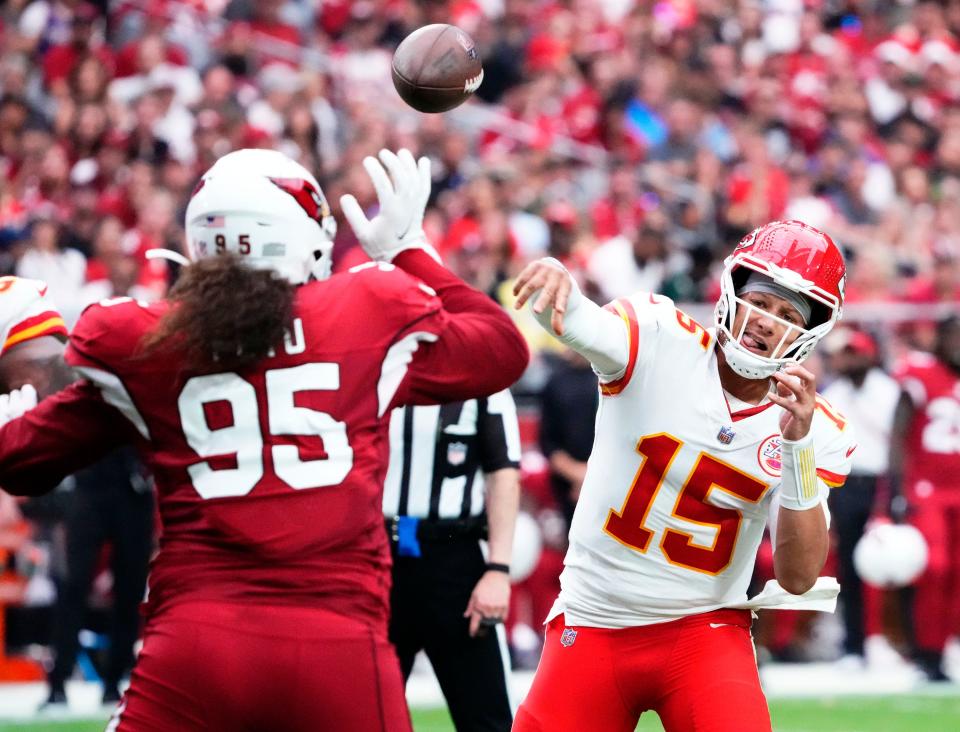 Sep 11, 2022; Glendale, Arizona, USA; Kansas City Chiefs quarterback Patrick Mahomes (15) throws a pass over Arizona Cardinals defensive tackle Leki Fotu (95) in the first half of the season opener at State Farm Stadium.