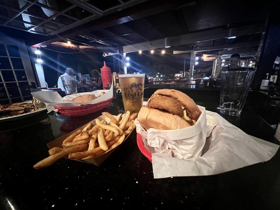 A burger and fries and drink on counter at restaurant
