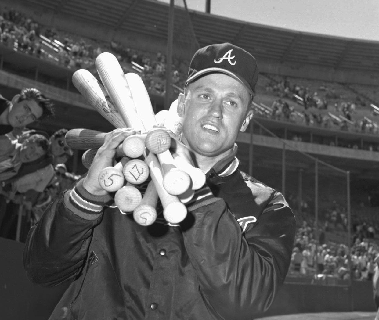 Cloninger lugs around an armload of bats after his historic day at the plate. (Robert 