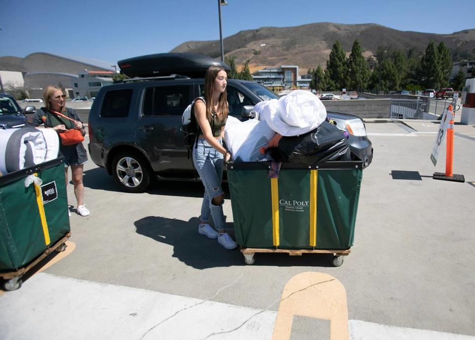 Andrea Noleroth watches daughter Avery Noleroth, a history major, push the familiar green bins packed with her belongings to her dorm on Tuesday, Sept. 13, 2022, as the university’s new freshman class arrived on campus.