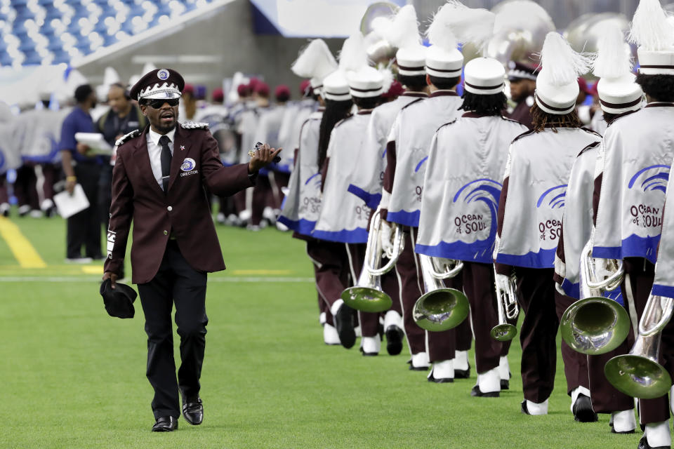 Texas Southern University Ocean of Soul marching band director Brian Simmons, left, organizes band members on the sidelines before they perform in the 2023 National Battle of the Bands, a showcase for HBCU marching bands, held at NRG Stadium, Saturday, Aug. 26, 2023, in Houston. (AP Photo/Michael Wyke)