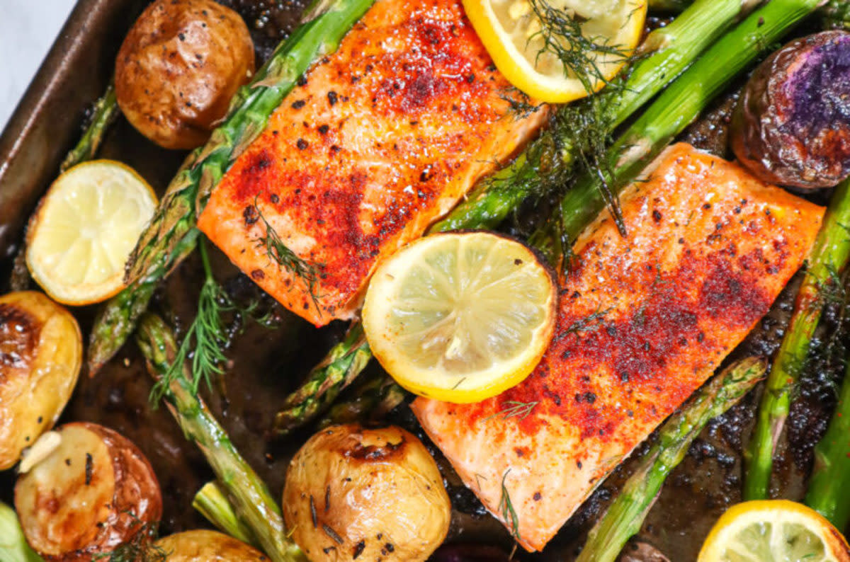 <p>Good Food Baddie</p><p>This easy sheet pan salmon with roasted asparagus, herb-crusted potatoes and luscious avocado crema is perfect for a quick, healthy, filling meal that everyone will enjoy!</p><p><strong>Get the Recipe: </strong><a href="https://goodfoodbaddie.com/easy-sheet-pan-salmon-dish/" rel="nofollow noopener" target="_blank" data-ylk="slk:Easy Sheet Pan Salmon Dish;elm:context_link;itc:0;sec:content-canvas" class="link rapid-noclick-resp"><strong>Easy Sheet Pan Salmon Dish</strong></a></p>