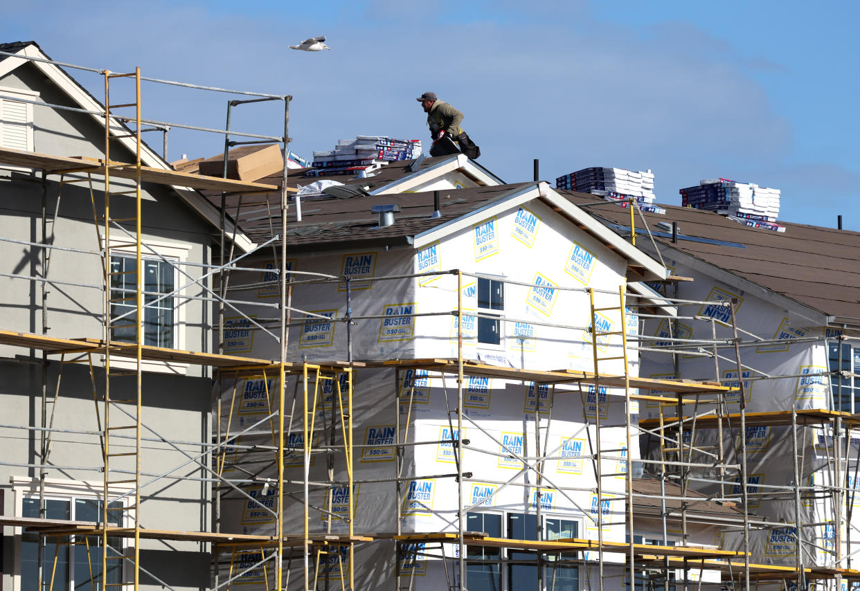 NEWARK, CALIFORNIA - DECEMBER 15: A worker makes repairs to a home under construction at the Lennar Bridgeway home development on December 15, 2021 in Newark, California. Homebuilder Lennar will report fourth quarter earnings today after the closing bell. (Photo by Justin Sullivan/Getty Images)