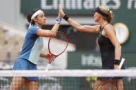 France's Caroline Garcia, left, and France's Kristina Mladenovic celebrate scoring a point as they play Coco Gauff of the U.S. and Jessica Pegula of the U.S. during their women doubles final match of the French Open tennis tournament at the Roland Garros stadium Sunday, June 5, 2022 in Paris. (AP Photo/Jean-Francois Badias)