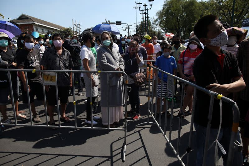 People line up to buy shrimps from anti government protesters selling shrimps in front of government house amidst the COVID-19 outbreak in Bangkok