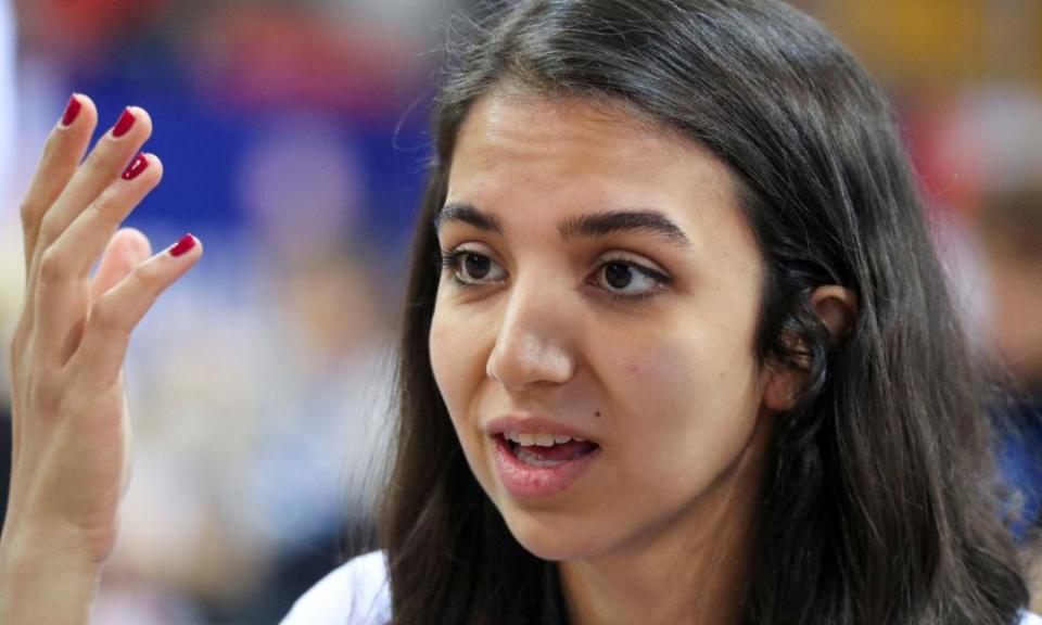 Sara Khadem gestures with her hand during a chess match.