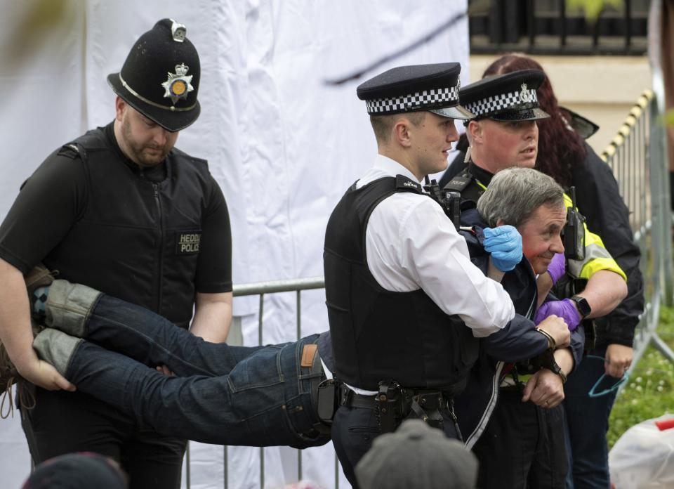 Police move in to crowd to detain “Just Stop Oil” protestors before the King’s Procession in London.