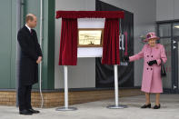 Britain's Prince William looks on as Queen Elizabeth II unveils a plaque to officially open the new Energetics Analysis Centre at the Defence Science and Technology Laboratory (DSTL) at Porton Down, England, Thursday Oct. 15, 2020, to view the Energetics Enclosure and display of weaponry and tactics used in counter intelligence. (Ben Stansall/Pool via AP)