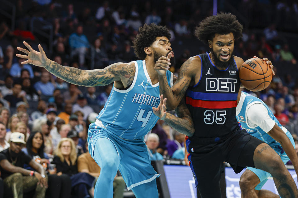 Detroit Pistons forward Marvin Bagley III (35) drives against Charlotte Hornets center Nick Richards (4) during the first quarter of an NBA basketball game in Charlotte, N.C., Friday, Oct. 27, 2023. (AP Photo/Nell Redmond)