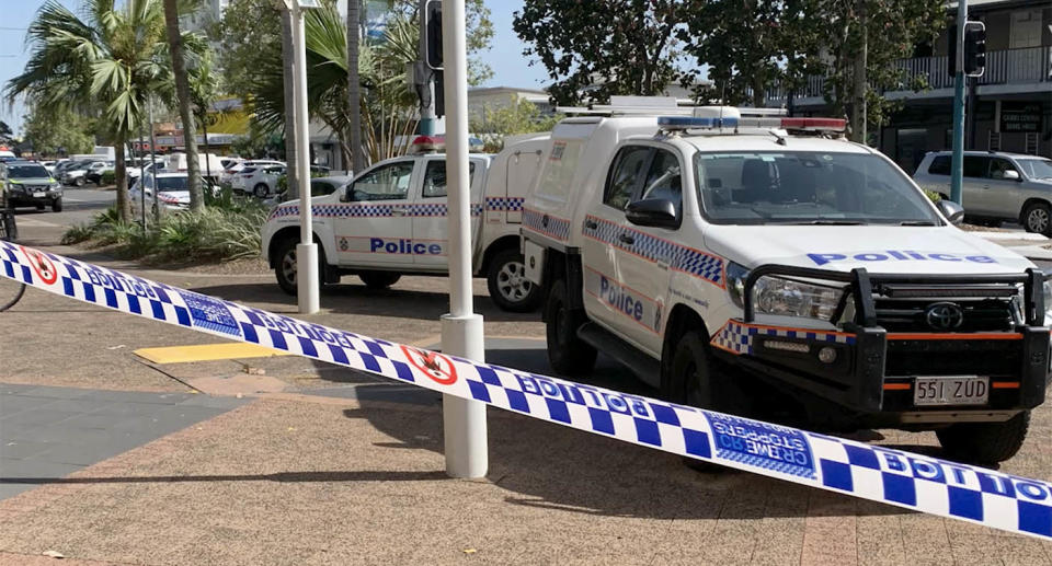 Two police cars sit outside Cairns Central Shopping Centre.