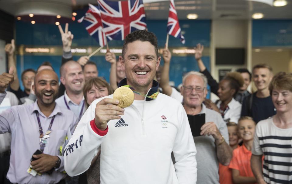 Rose posing for a photograph with his gold medal after the last Olympics - GETTY IMAGES