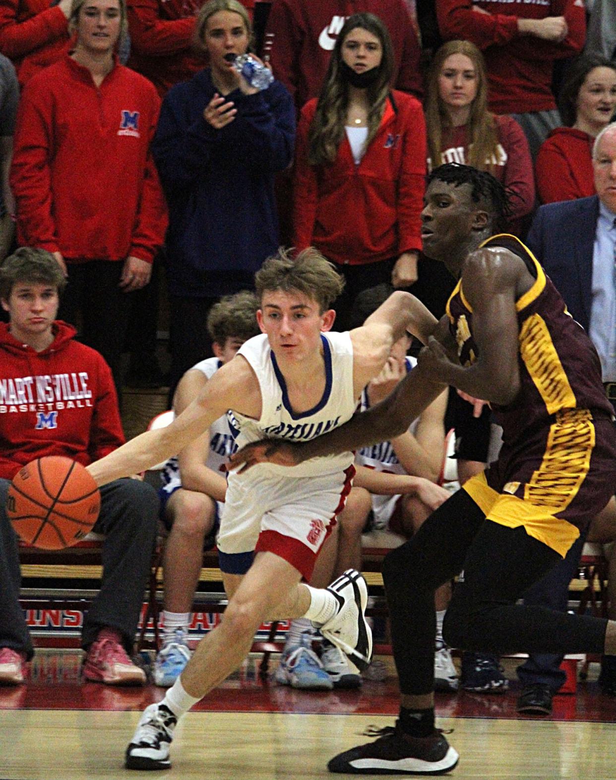 Martinsville junior Skyler Pruett dribbles around his defense during Friday's game at home against Bloomington North. 