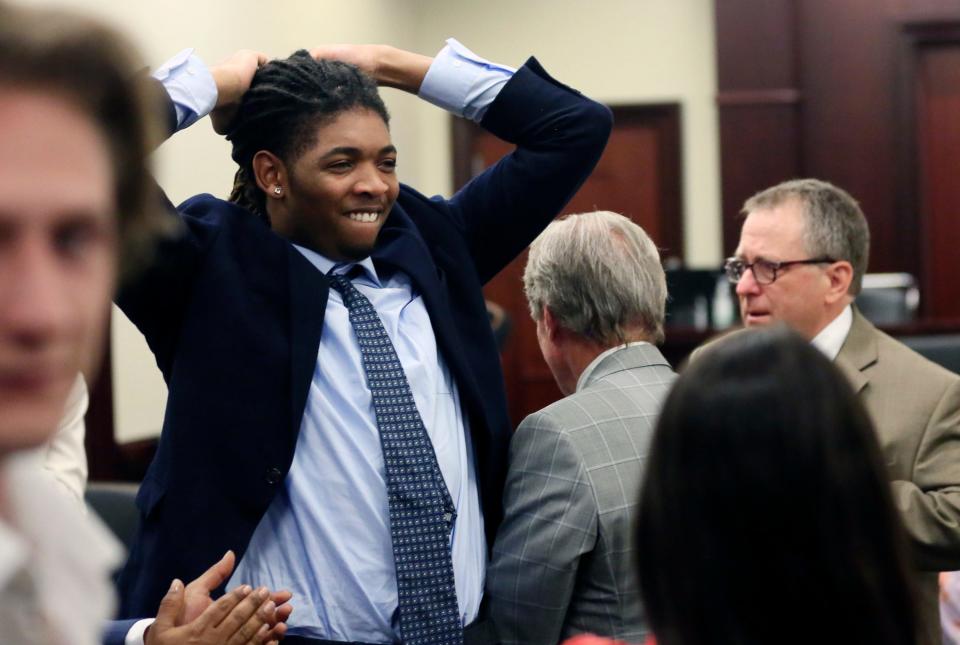 Isimemen Etute celebrates at the end of his trial in Montgomery County Circuit Court Friday, May 27, 2022 in Christiansburg Va.