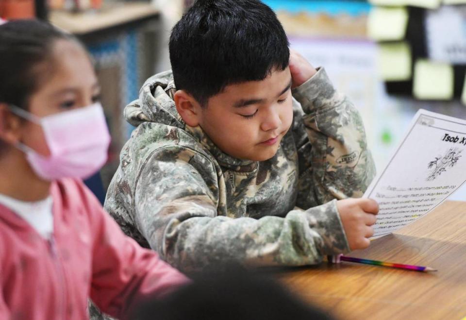 Lyam Vang, a third-grade student, studies a lesson in Fresno Unified’s Hmong Dual Immersion program at Vang Pao Elementary Thursday, Feb. 23, 2023 in Fresno.