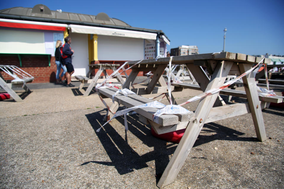 Benches are wrapped in tape at a cafe on Hove seafront as the UK continues in lockdown to help curb the spread of the coronavirus.