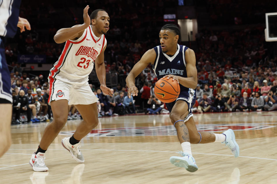 Maine's Kellen Tynes, right, drives to the basket against Ohio State's Zed Key during the first half of an NCAA college basketball game on Wednesday, Dec. 21, 2022, in Columbus, Ohio. (AP Photo/Jay LaPrete)