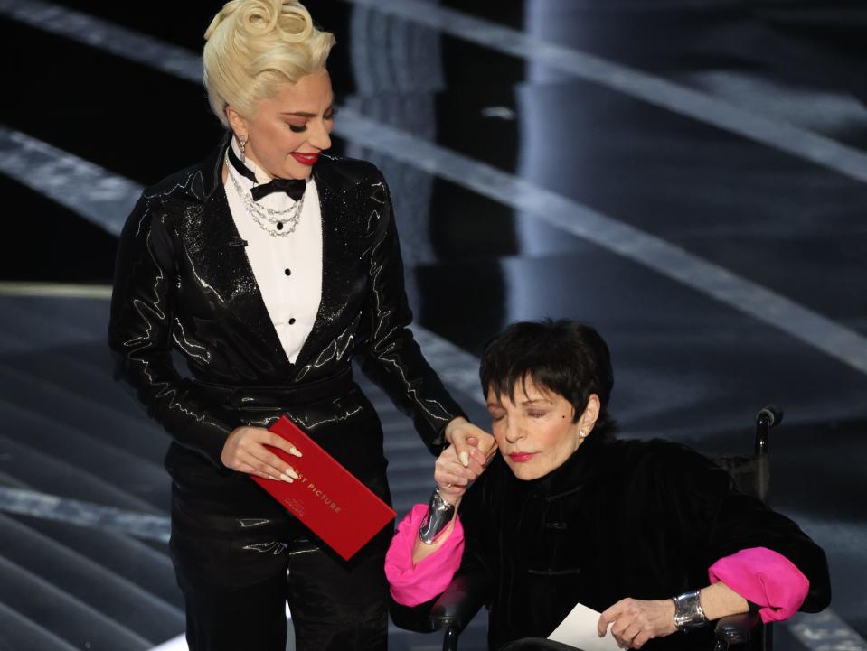 Lady Gaga holds Liza Minnelli's hand onstage at the Oscars