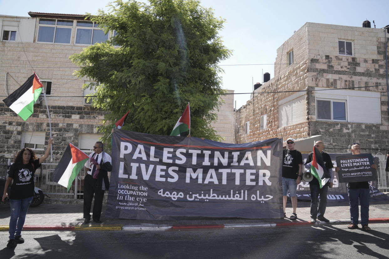 Protesters hold posters for slain Palestinian-American journalist Shireen Abu Akleh near the Augusta Victoria Hospital in east Jerusalem ahead of a visit by President Biden, Friday, July 15, 2022. (AP Photo/Maya Alleruzzo)