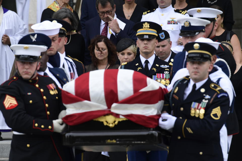 <p>The casket of Sen. John McCain, R-Ariz., is carried out of the Washington National Cathedral in Washington, Saturday, Sept. 1, 2018, after a memorial service, as Cindy McCain is escorted by her son Jimmy McCain and other family members. (Photo: Susan Walsh/AP) </p>