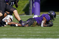 Northwestern defensive back Coco Azema, right, recovers a fumble by Ohio quarterback Kurtis Rourke, left, during the first half of an NCAA college football game in Evanston, Ill., Saturday, Sept. 25, 2021. (AP Photo/Nam Y. Huh)