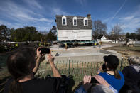 The Bray School is aligned with a set foundation at its new location in Colonial Williamsburg in Williamsburg, Va. on Friday, Feb. 10, 2023 after it was moved from the William & Mary campus. It is believed to be the oldest surviving schoolhouse for Black children in the U.S., built 25 years before the American Revolution. (Billy Schuerman/The Virginian-Pilot via AP)