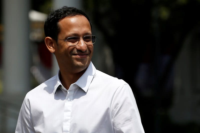 Nadiem Makarim, founder of the Indonesian ride-hailing and online payment firm Gojek waves to journalists as he arrives at the Presidential Palace in Jakarta