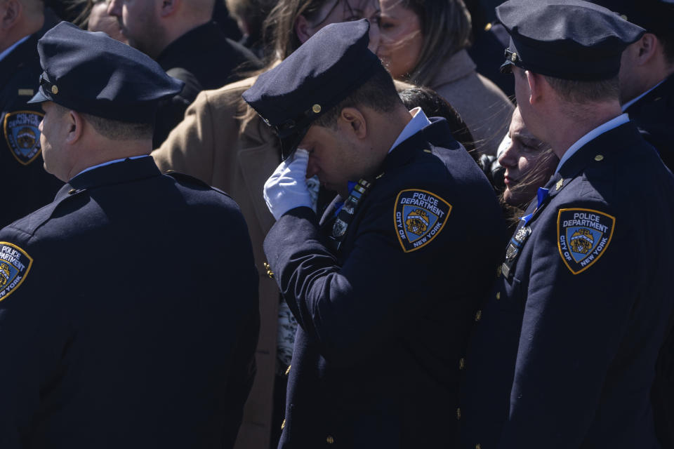 Family members react during a funeral service for New York City Police Department officer Jonathan Diller at Saint Rose of Lima R.C Church in Massapequa Park, N.Y., on Saturday, March 30, 2024. Diller was shot dead Monday during a traffic stop. He was the first New York City police officer killed in the line of duty in two years.(AP Photo/Jeenah Moon)