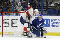 Florida Panthers center Aleksander Barkov (16) works for the puck in front of Tampa Bay Lightning goaltender Andrei Vasilevskiy (88) during the second period of an NHL hockey game Monday, Dec. 23, 2019, in Tampa, Fla. (AP Photo/Chris O'Meara)