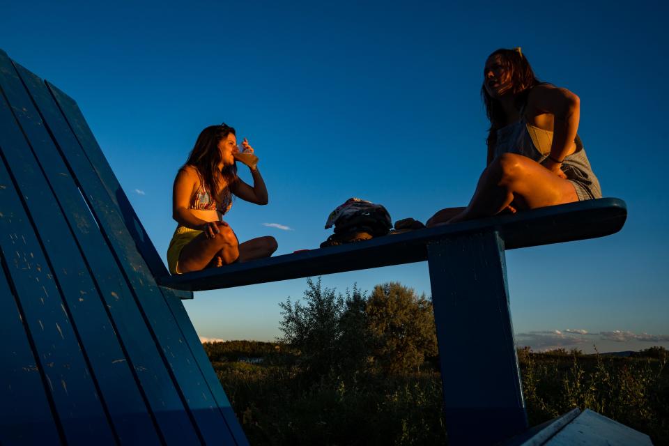 Ashley Manera, left, and Lina Rettig enjoy an evening with beer and quotes from "The Grinch" at Paddler's Pub in Fort Collins on Aug. 4, 2023.