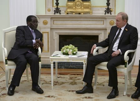 FILE PHOTO: Russian President Vladimir Putin meets with his Zimbabwean counterpart Robert Mugabe at the Kremlin in Moscow