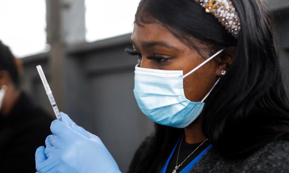 A medical worker prepares to administer a vaccine at a drive-through site at the Strawberry Festival Fairgrounds in Plant City, Florida, on 13 January.