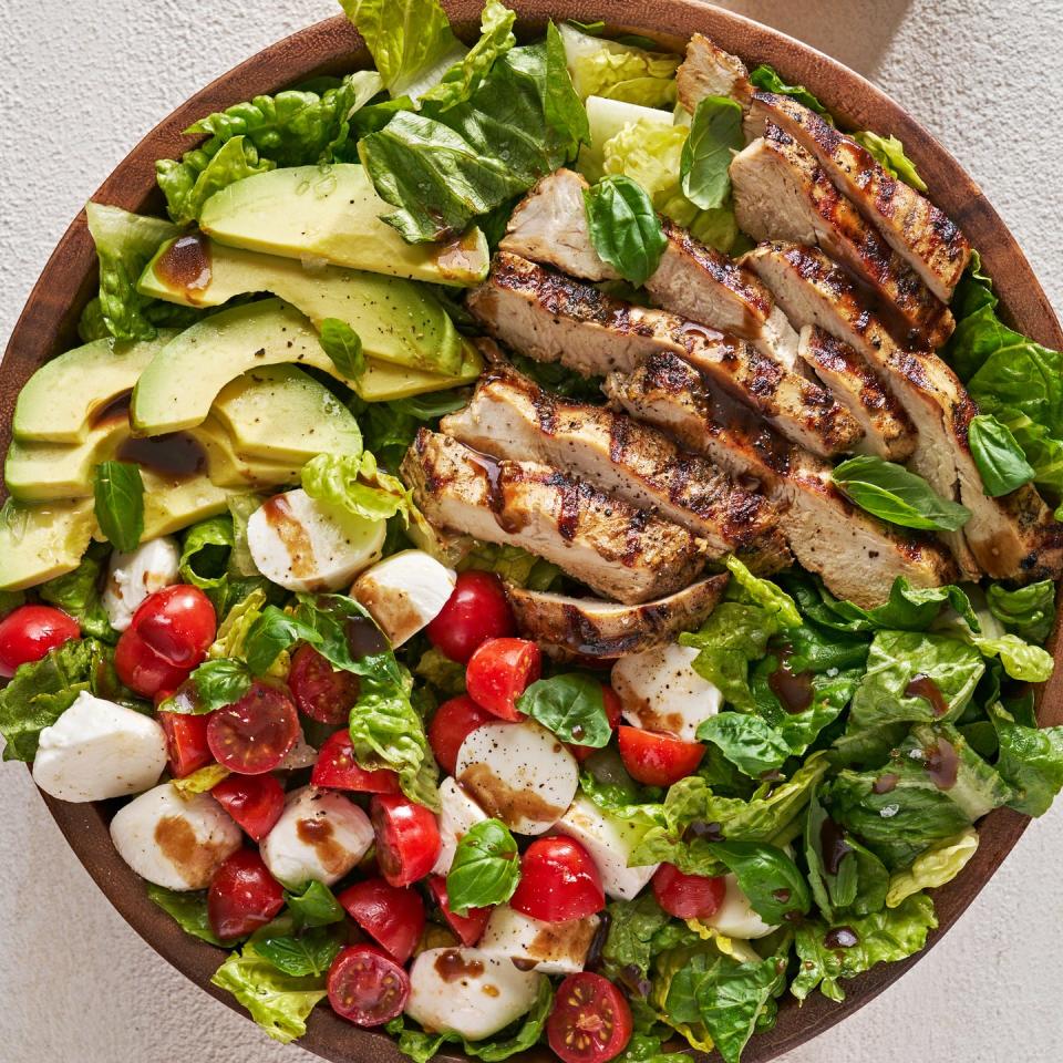 chicken avocado caprese salad in a bowl with balsamic dressing