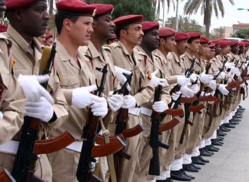 Libyan soldiers stand on parade at Mitiga International airport in Tripoli, during a guided government tour. Turkey says it has offered Moamer Kadhafi guarantees to leave Libya but has yet to receive a reply, while rebels have accused his forces of shelling a UNESCO world heritage site