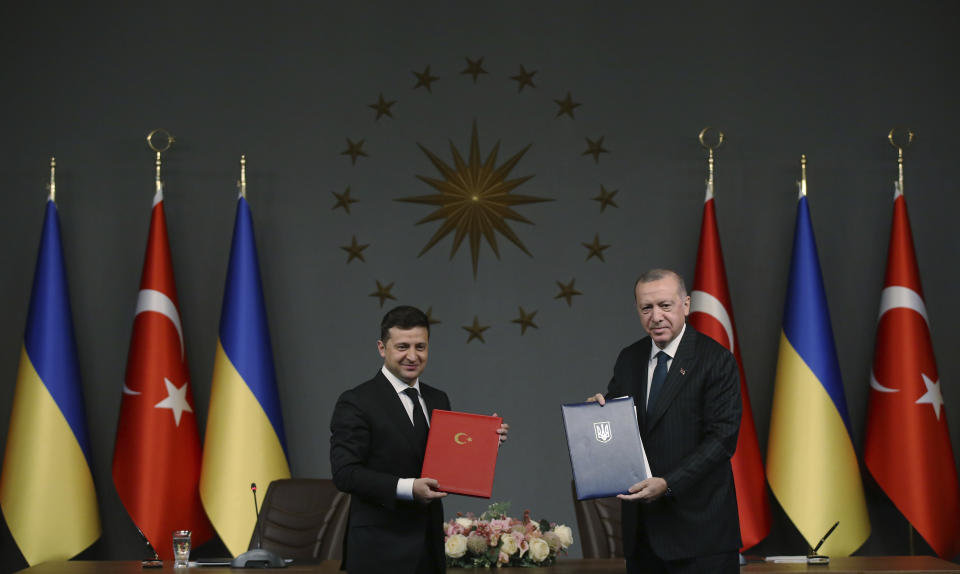Turkish President Recep Tayyip Erdogan, right, and Ukrainian President Volodymyr Zelenskiy pose for photographs after they signed agreements, in Istanbul, Friday, Oct. 16, 2020. President Zelenskiy is in Istanbul for a one-day working visit. (Turkish Presidency via AP, Pool)