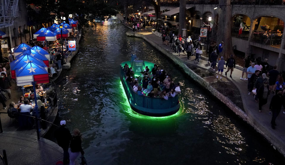 Visitors crowd the River Walk in San Antonio, Thursday, March 18, 2021, as the city prepares to host the Women's NCAA College Basketball Championship. (AP Photo/Eric Gay)