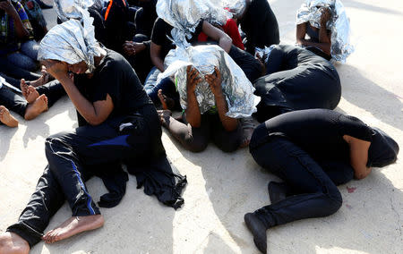 FILE PHOTO: Migrants at a naval base after being rescued by Libyan coast guards in Tripoli, Libya, June 18, 2018. REUTERS/Ismail Zitouny/File Photo