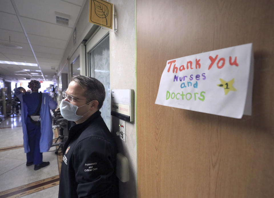 FILE - In this Nov. 5, 2020, file photo, a thank you note for staff at UW Health is displayed on a wall inside a COVID-19 treatment unit as Dr. Andrew Braun, a physician on the unit stands by in Madison, Wis. In Wisconsin, hospitalizations dropped dramatically over the last three and a half months, from a high of 2,277 patients on Nov. 17 to 355 on Wednesday, Feb. 24, 2021, according to the Wisconsin Hospital Association. (John Hart/Wisconsin State Journal via AP, File)