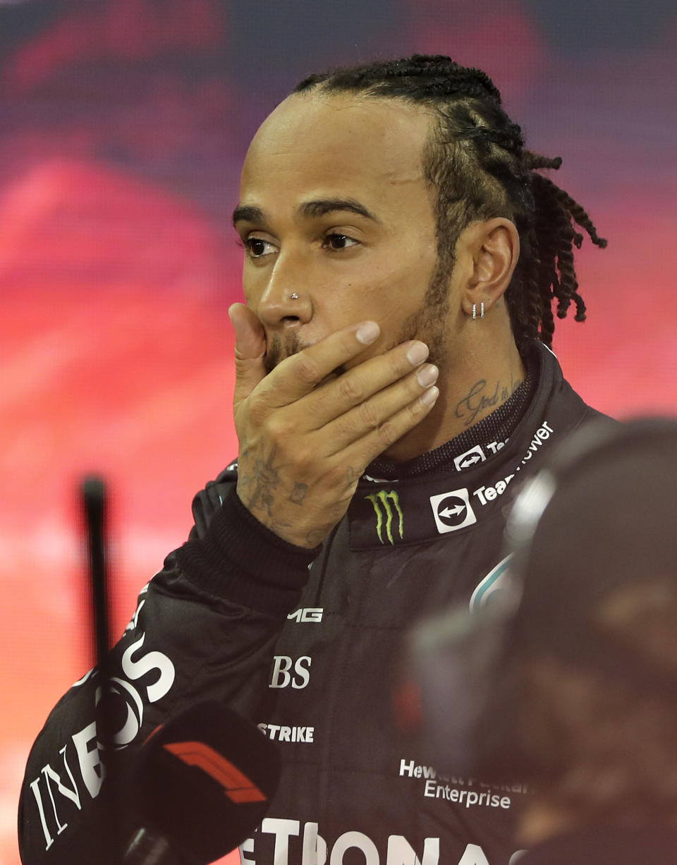 Mercedes driver Lewis Hamilton of Britain reacts after finishing second in the Formula One Abu Dhabi Grand Prix in Abu Dhabi, United Arab Emirates, Sunday, Dec. 12. 2021. Max Verstappen ripped a record eighth title away from Lewis Hamilton with a pass on the final lap of the Abu Dhabi GP to close one of the most thrilling Formula One seasons in years as the first Dutch world champion. (AP Photo/Kamran Jebreili, Pool)