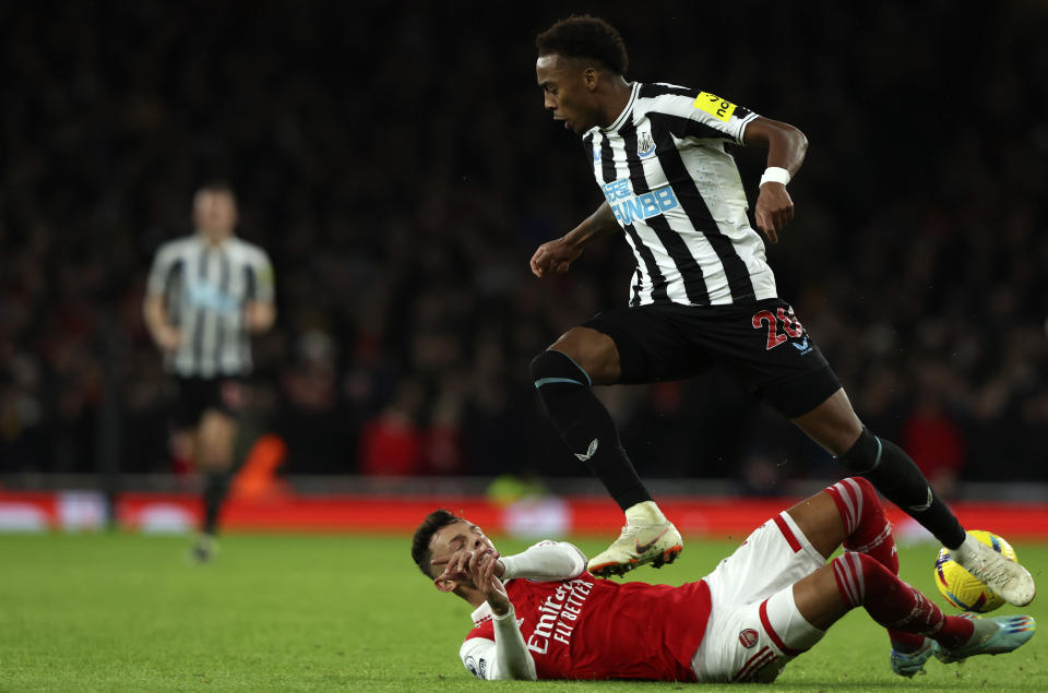 Newcastle's Joe Willock, top, duels for the ball with Arsenal's Ben White during the English Premier League soccer match between Arsenal and Newcastle United at Emirates stadium in London, Tuesday, Jan. 3, 2023. (AP Photo/Ian Walton)