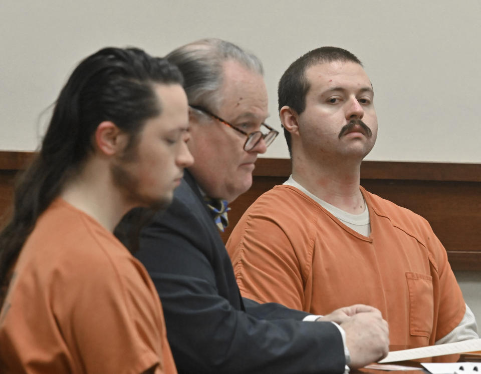 Jacob Kaderli, left, and Michael Helterbrand, right, sit with Helterbrand's attorney Radford Bunker as Kaderli's attorney John Lovell (not pictured) speaks before Floyd County Superior Court Judge Jack Niedrach (not pictured) at Floyd County Superior Court in Rome, Ga., on Friday, Feb. 14, 2020. Bond was denied Friday for the two Georgia men authorities say are linked to a violent white supremacist group known as The Base. The two men are charged, along with 22-year-old Luke Lane of Silver Creek, of conspiring to kill members of a militant anti-fascist group and participating in a criminal gang. (Hyosub Shin/Atlanta Journal-Constitution via AP)/