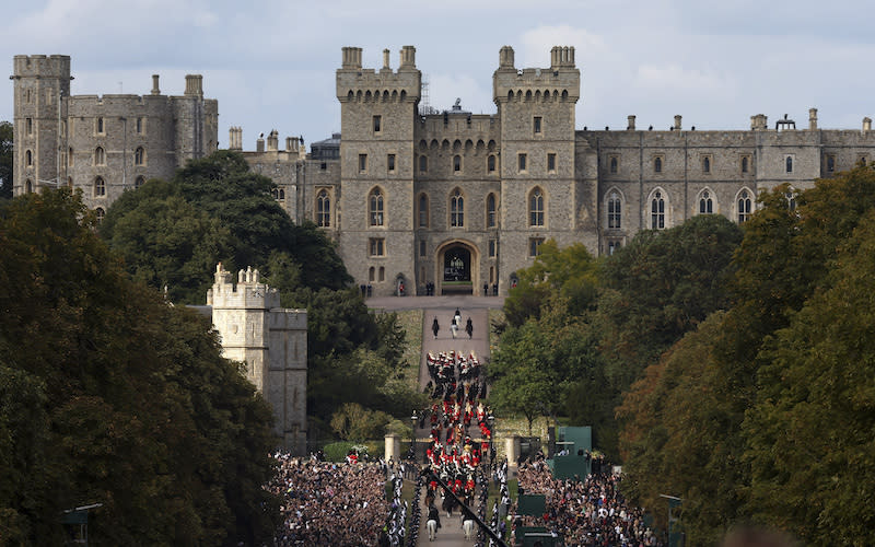 The coffin of Queen Elizabeth II is carried in a hearse along the Long Walk toward Windsor Castle during her funeral procession in Windsor.