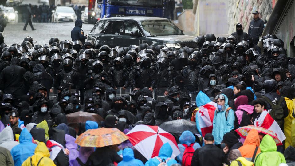 Protesters stare down riot police outside the Georgian Parliament. - Irakli Gedenidze/Reuters