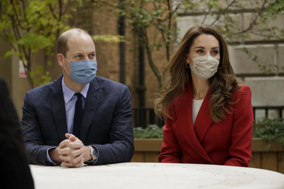 LONDON, ENGLAND - OCTOBER 20: Prince William and Catherine, Duchess of Cambridge meet pharmacist Joyce Duah as they visit St. Bartholomew's Hospital in London, to mark the launch of the nationwide 'Hold Still' community photography project, on October 20th, 2020 in London, England.  The Duke and Duchess of Cambridge on Tuesday met a small number of staff from the hospital, including pharmacist and photographer Joyce Duah and the two pharmacy technician colleagues she photographed writing on their PPE as they put it on, in a photograph that was selected to be in the set of 100 images taken during the coronavirus lockdown. (Photo by Matt Dunham - WPA Pool/Getty Images)