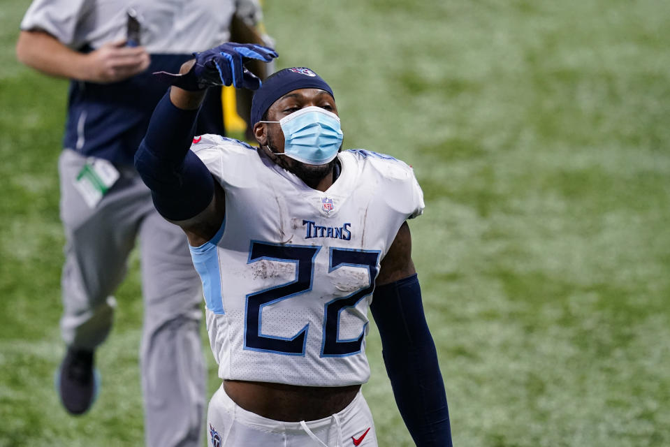 Tennessee Titans running back Derrick Henry (22) salutes fans as he walks off the field following an NFL football game against the Indianapolis Colts in Indianapolis, Sunday, Nov. 29, 2020. The Titans defeated the Colts 45-26. (AP Photo/Darron Cummings)